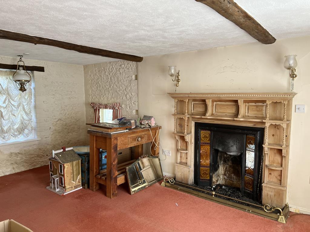 Lot: 65 - THREE-BEDROOM COTTAGE ON PLOT OF 0.34 ACRES FOR IMPROVEMENT - Living room with feature fireplace